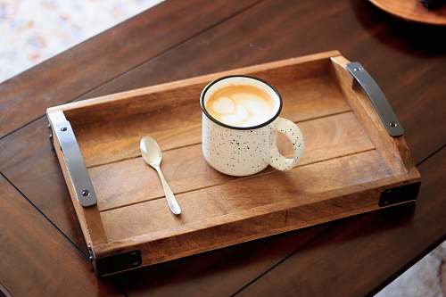 drink white ceramic mug on brown wooden serving tray coffee table