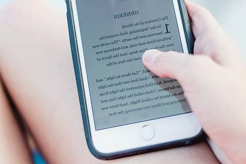 text person holding turn-on iPhone church