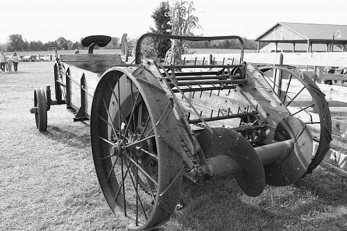 machine grayscale photo of carriage wheel