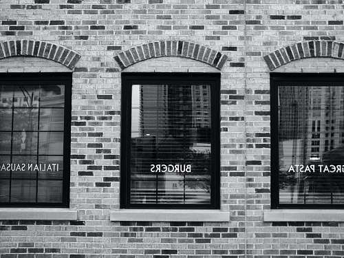 brick grayscale photography of building with glass windows chicago
