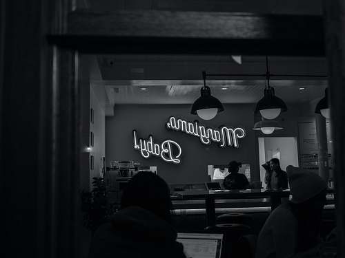 human grayscale photography of Margiamo Baby! neon sign person