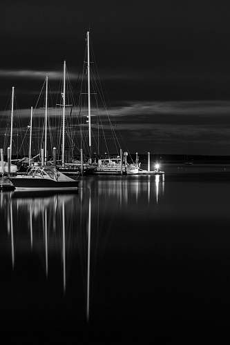 transportation greyscale photo of boat on top of water vessel