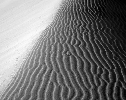 sand greyscale photo of desert soil