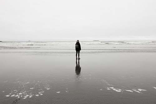 grey person standing near sea at daytime ruby beach