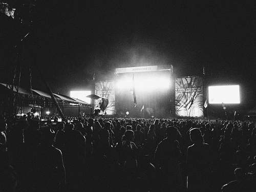 indoors photography of people gathering near outdoor in front of stage during nighttime interior design