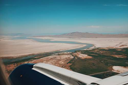 dinghy aerial photography of open field surrounded with body of water transportation