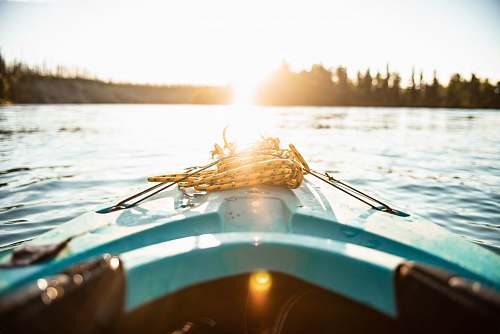 kenai blue kayak on body of water during golden hour dinghy