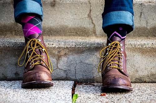 clothing person in brown suede boots and pink socks footwear