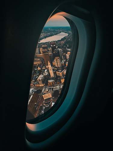 cushion view of city buildings from plane window headrest