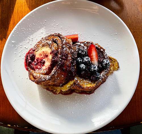 food pastry with sliced strawberry and blueberries on plate 210 water st