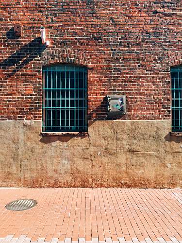 wall black metal window on brown brick wall path