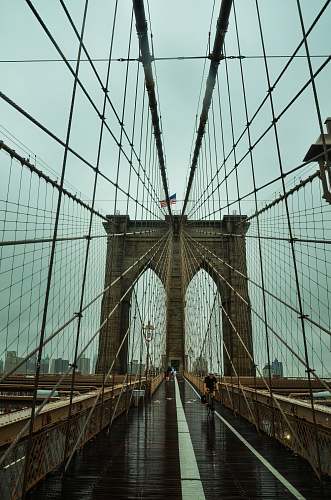 building man riding bike on bridge human