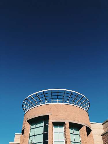 architecture brown and white concrete building under blue sky during daytime tower