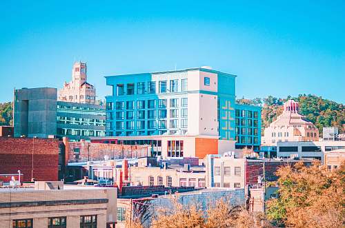city brown and white concrete building under blue sky during daytime town
