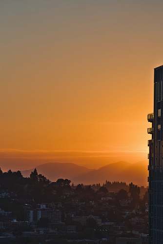 architecture city building across mountain during sunset tower