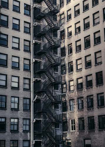 city gray concrete buildings with metal exit stairs urban