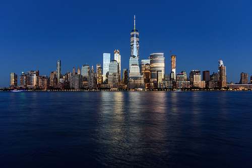 city landscape shot of buildings surrounded body of water urban