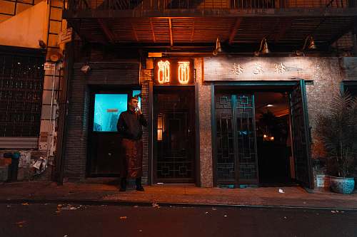 chinatown man standing near house during night new york