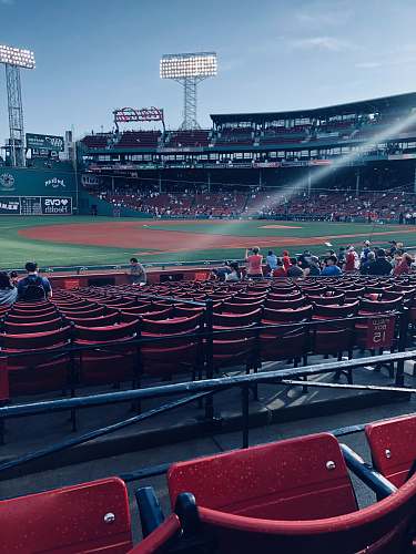 human people sitting inside baseball arena during daytime person