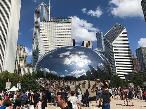 city people walking on park near cloud gate during daytime downtown