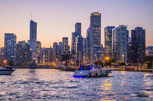 city white and blue yacht on body of water during daytime town
