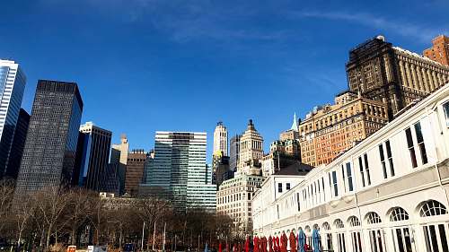 city white and brown concrete building under blue sky during daytime downtown