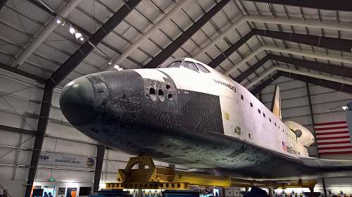transportation white and gray plane inside gray shed hangar