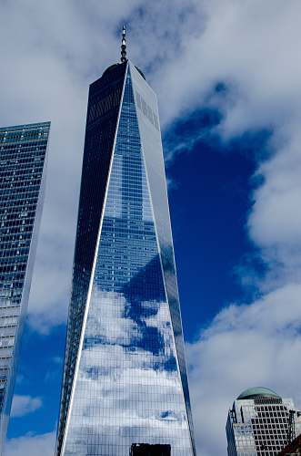 city white clouds over glass facade high rise building urban