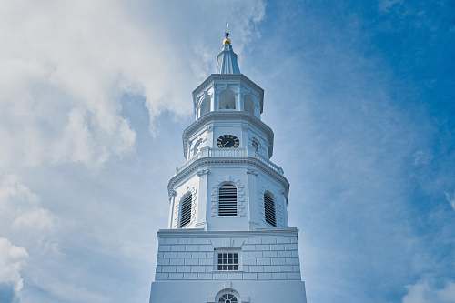 architecture white concrete clock tower during daytime tower