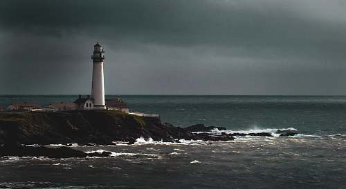 lighthouse white lighthouse beside shore beacon