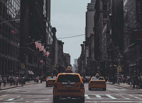 taxi orange vehicle passing on road manhattan