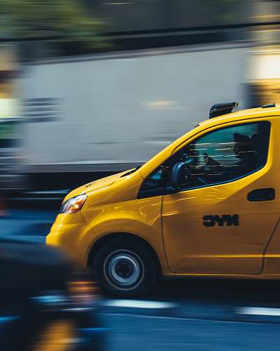 taxi time lapse photography of yellow car automobile