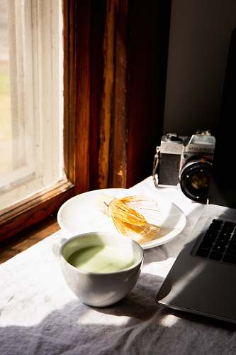 electronics white ceramic tea cup beside white ceramic plate breakfast
