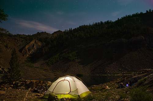 tent white camping tent near the hill leisure activities