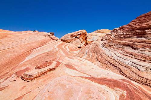 mountain low-angle photography of brown mountains under blue sky during daytime blue