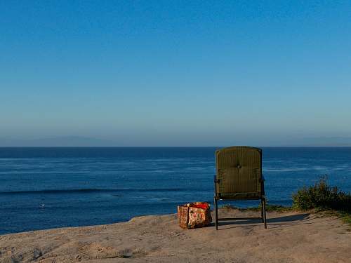 furniture brown armchair near sea shore horizon