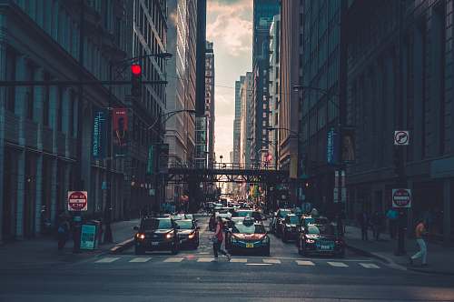 urban woman crossing pedestrian lane towards building during daytime chicago