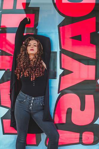 apparel woman leaning on wall pants