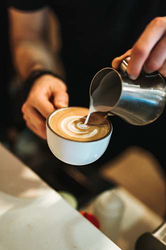cup person preparing latte with art coffee cup