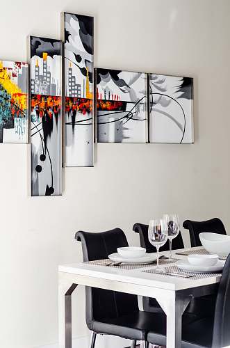 poster two clear wine glasses on white wooden dining table chair