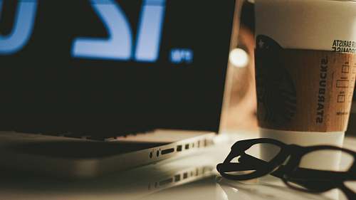 electronics eyeglasses beside laptop computer pc