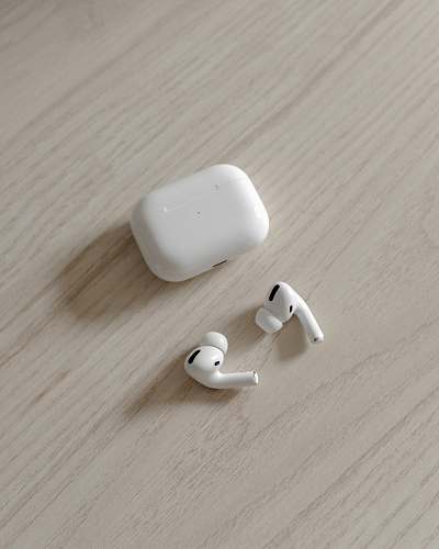 electronics white apple airpods on brown wooden table hardware