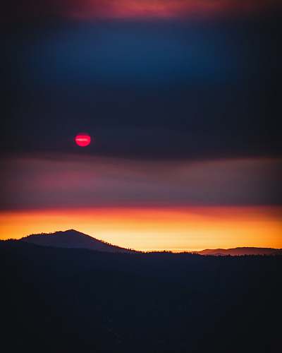 dusk silhouette view of mountain under red moon nature