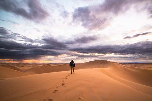 sand man walking on desert glamis