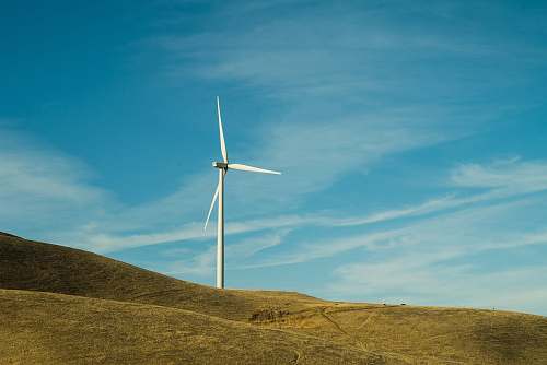 machine white windmill on hill during daytime motor