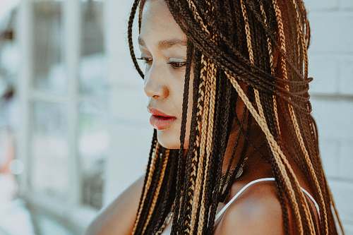 girl selective focus photography of woman with braided hair woman