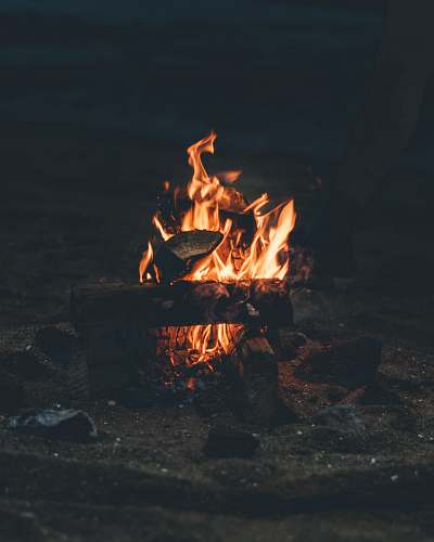 bonfire flaming bonfire on grey sand flame