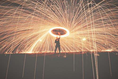 night man holding fireworks outdoors