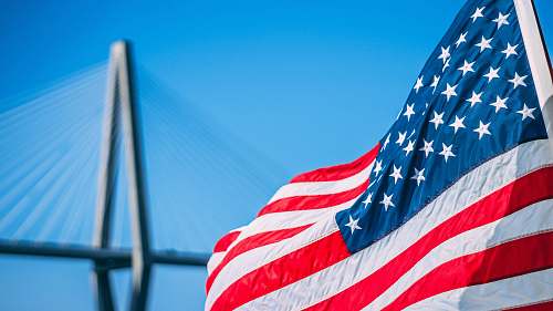 symbol us a flag on pole during daytime charleston
