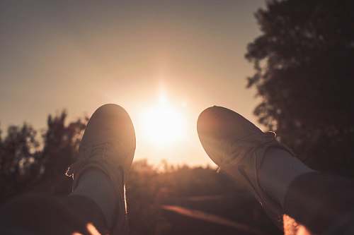 light person wearing white Nike lace-up sneakers during golden hour lake oswego